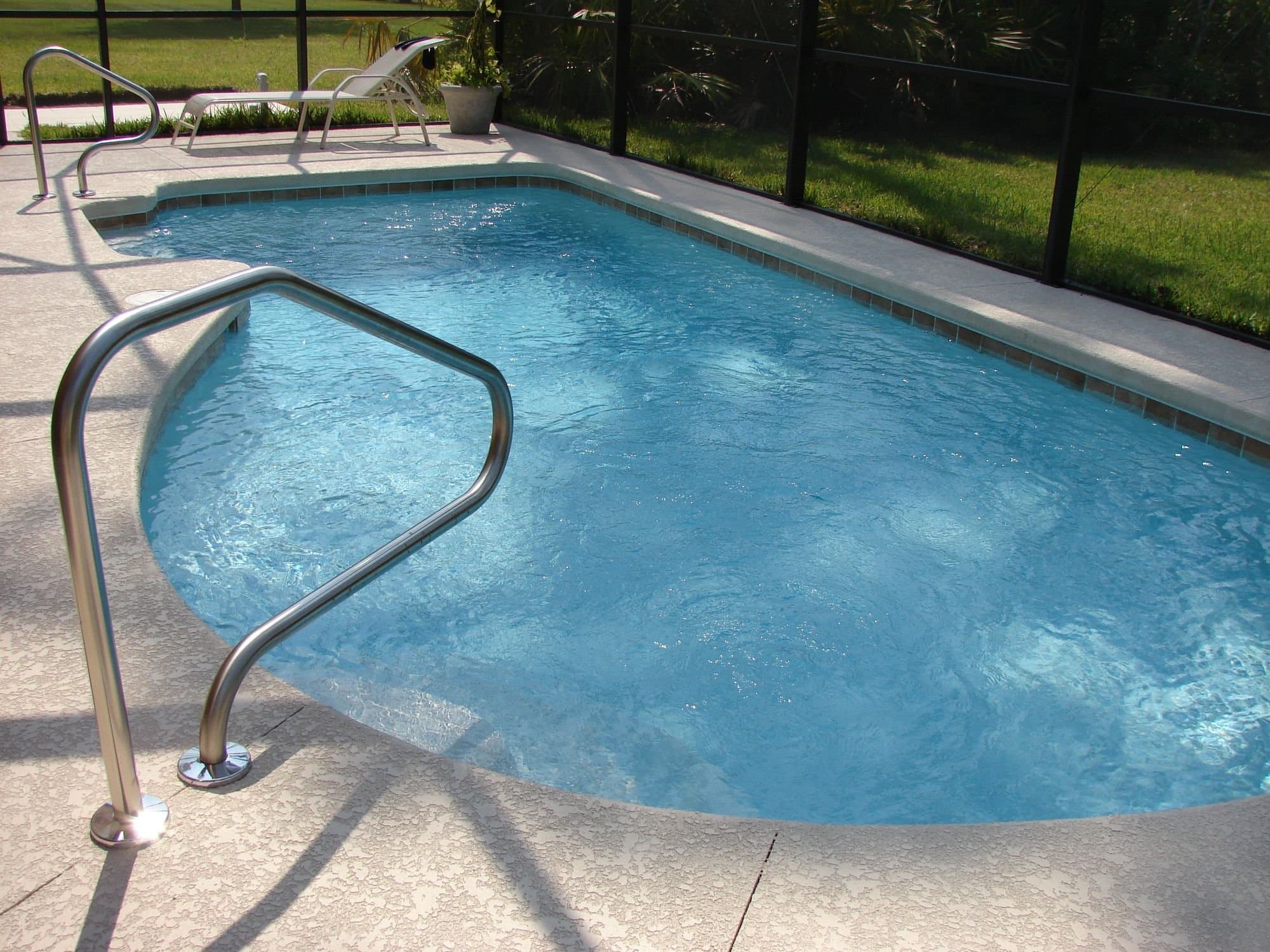 Pool and deck inside a Florida screen enclosure — licensed example photo (not a Karhan project)