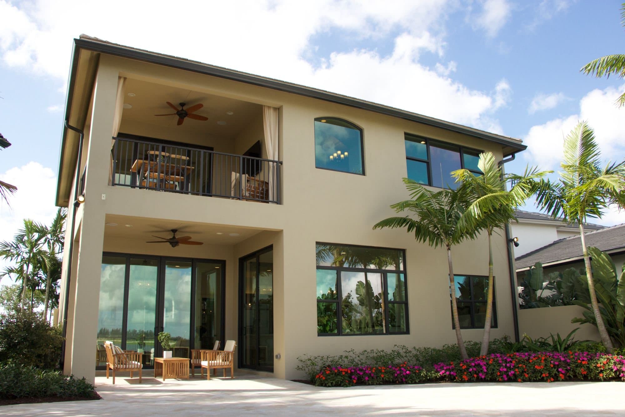 Florida home with covered lanai and tropical landscaping — licensed example photo (not a Karhan project)