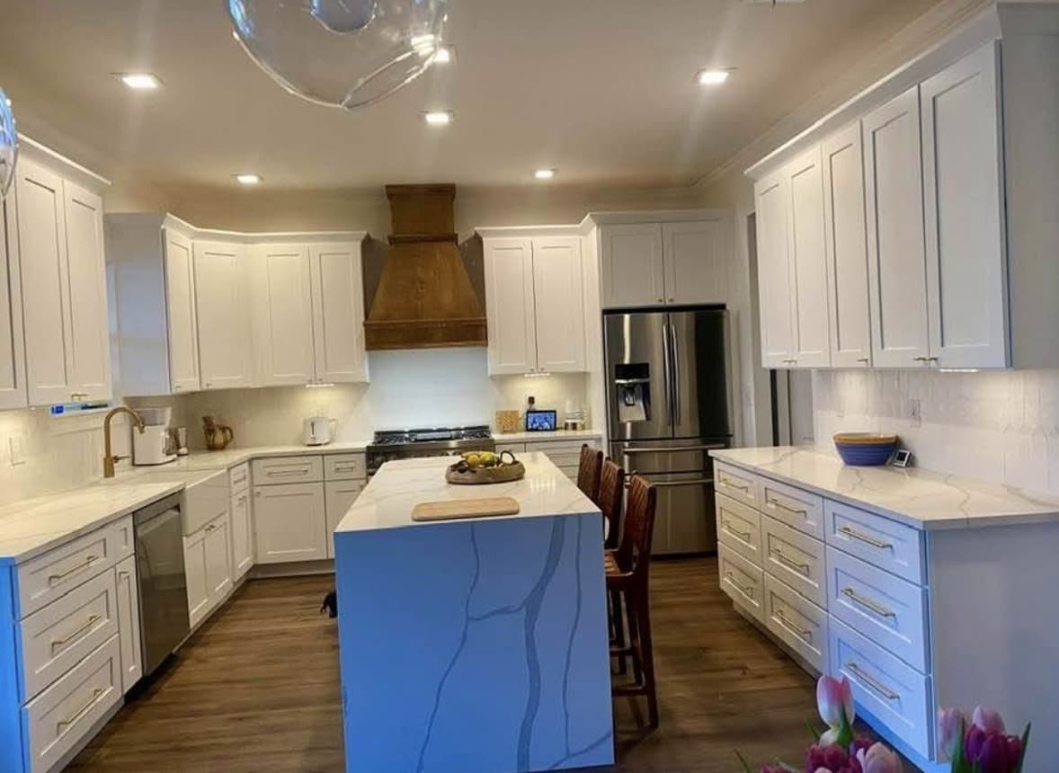 Real Karhan kitchen remodel — white shaker cabinets and custom wood range hood, Orlando area