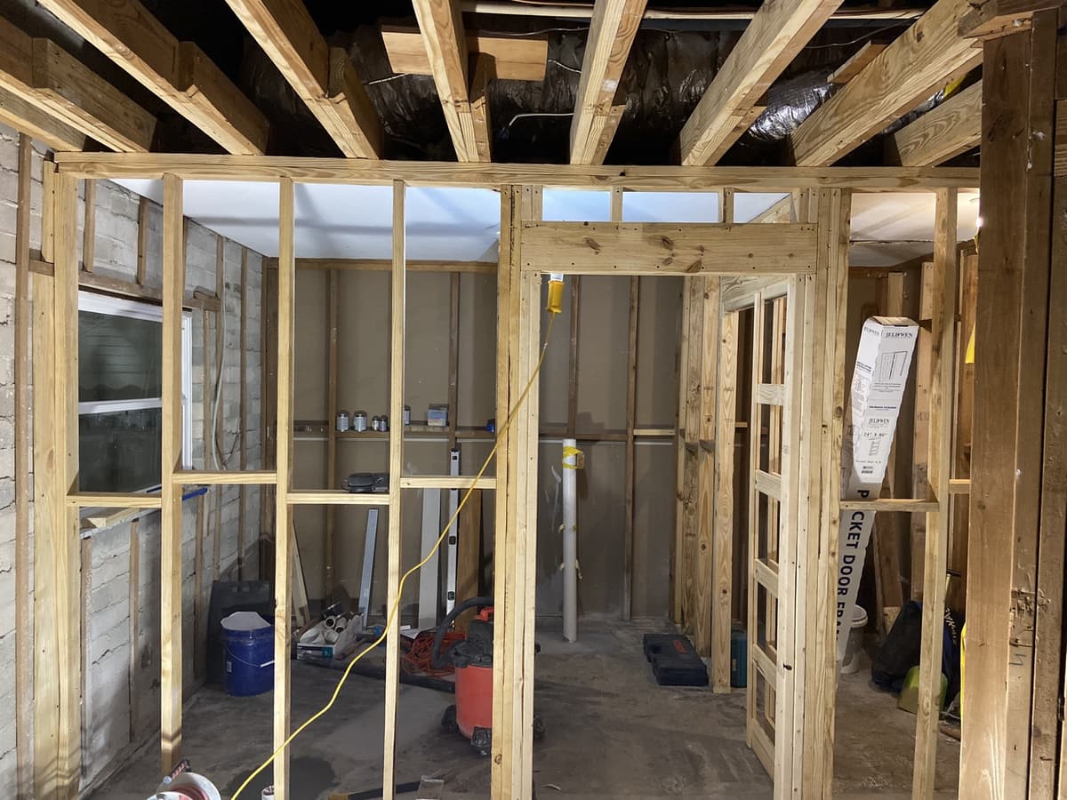Real Karhan whole-home renovation — interior reframed to the studs with new partition walls and pocket-door framing, Orlando area